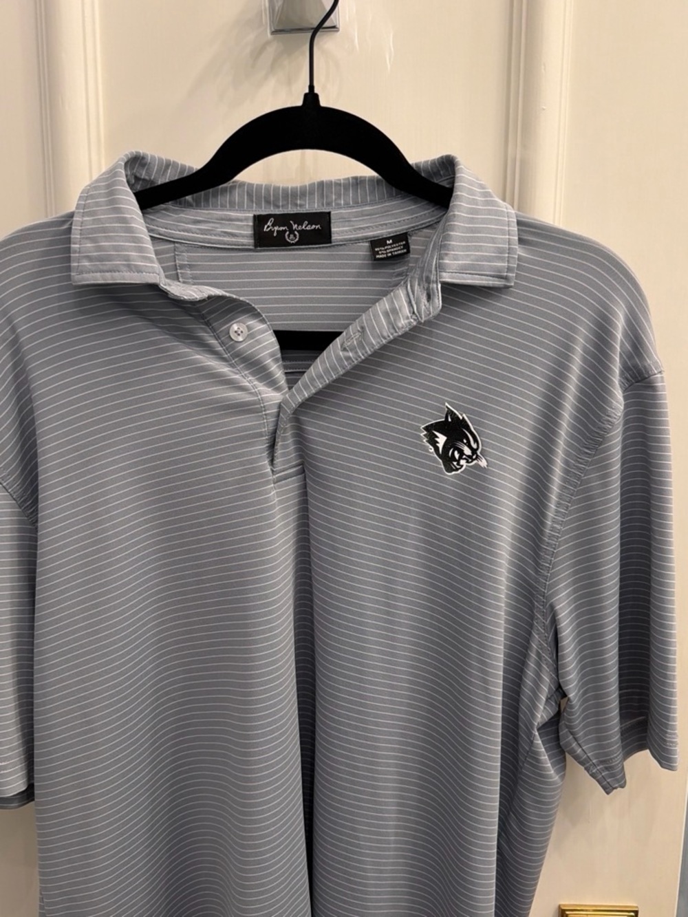 Ryan Wallace Light Blue Striped Polo with Wolf Logo